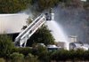 North Little Rock fire crews and equipment spray water onto the rear of the Onyx Laboratories plant at 9600 Rowlett Drive after a blaze broke out Thursday morning. 