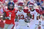 Arkansas running back Dennis Johnson (33) tries to outdistance Mississippi defender Damien Jackson (1) during a second-quarter 52-yard run for the Razorbacks’ first touchdown in a 29-24 victory over the Rebels in Oxford, Miss., on Saturday.