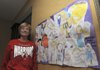 Angela Blagg shows a poster students at Westside Elementary School in Rogers created to encourage her in her battle with cancer. The school community has rallied around Blagg, raising nearly $7,000 and lots of emotional support.
