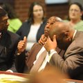 Raymond Robert Lee Douglas (left) and his attorney, Ronald Davis Jr., react Wednesday in Fayettevill...