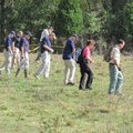 Searchers sweep through a section of a pasture Wednesday near where a human skull was found in a cre...