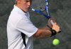 Austin Crawford of Little Rock Central hits a return shot to Conway Christian’s Drew Dodge during Crawford’s 6-0, 6-2 victory on Wednesday in the state overall high school tennis tournament at Burns Park in North Little Rock. 