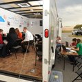 Prairie Grove High School students, from left, David Smith, Ayron McGee and Danielle Smith work with...