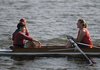 Andrew Correll, left, seated in what is called the coxswain seat also called the cox seat, talks to Wynn Dickenson seated in the stroke seat of a rowing shell that holds 5 people called a 4 plus cox shell. The coxswain is in charge of the crew and gives all the commands. He or she is responsible for crew safety along with steering and coach the crew.