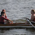 Andrew Correll, left, seated in what is called the coxswain seat also called the cox seat, talks to ...