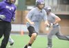 Matt McEver, center, a Fayetteville senior moves to the ball Thursday during the Purple’Dogs’ walk-through practice at Harmon Field in Fayetteville as they prepare for today’s game against Springdale Har-Ber.
