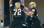 Vanderbilt quarterback Jordan Rodgers celebrates with teammates Kyle Fischer (72) and Fitz Lassing (38) after scoring a second-quarter touchdown against Arkansas on Saturday. 