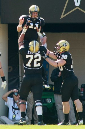 Vanderbilt quarterback Jordan Rodgers celebrates with teammates Kyle Fischer (72) and Fitz Lassing (38) after scoring a second-quarter touchdown against Arkansas on Saturday. 