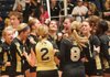 Taylor Riney (2) and Melanie Pickering (8) celebrate with teammates Saturday after winning the 7A State Volleyball Championship against Fayetteville at Buzz Bolding Arena at Conway High School.