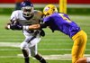 Brandon Cox, a Conway wide receiver, tries to turn the corner against a Little Rock Catholic defender during second half action in War Memorial Stadium on Nov. 3. The Wampus Cats will host Fayetteville on Friday in a Class 7A state playoff game.