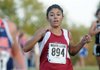 Torry Feole of Springdale High crosses the finish line at the 7A-West Conference cross country meet Oct. 25 at Rogers High.