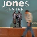 A man walks past the statue of Bernice Young Jones and Harvey Jones at the Jones Center in Springdal...