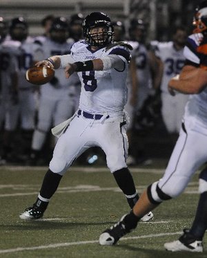 STAFF PHOTO J.S. WEDGEWORTH -- Fayetteville's Austin Allen looks for a reciever Friday, Nov. 4, 2011, while taking on Heritage High in Rogers.