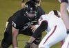 Ian Tucker, Bentonville offensive lineman, left, gets ready to square off Oct. 28 with the Springdale High defensive line.
