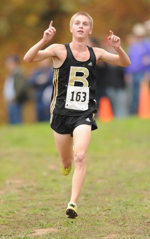  STAFF PHOTO ANDY SHUPE
Bentonville's Will Aechbacher celebrates as he nears the finish line Saturday, Nov. 5, 2011, during the state cross country championships in Harrison.