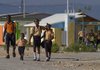  In this Oct. 27, 2011 photo, students walk past a row of new model homes on the outskirts of Port-au-Prince, Haiti. The struggle to rebuild homes for hundreds of thousands of quake victims may be giving the impoverished nation something it has never had: loans to help people buy them. If efforts by local agencies and international donors succeed, at least a few members of Haiti's small middle class will be able for the first time to get a mortgage. Some of the efforts reach even further, offering micro-mortgages for families who make as little as $150 a month. 