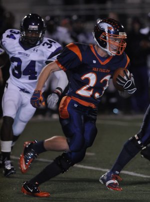 Rogers Heritage High’s John Stotts runs the ball Friday while hosting Fayetteville in Rogers.