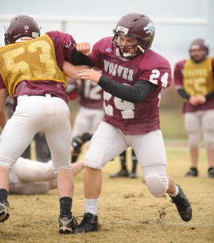 Dustin Simmons, Lincoln senior fullback, blocks Tuesday during practice at Lincoln High School.