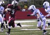Springdale High School’s Henry Hernandez, left, holds off Darian Neitzel of Rogers High on Friday during their game at Jarrell Williams Bulldog Stadium in Springdale.