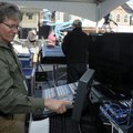 Fran Yount with Vista Productions configures electronics to broadcast and record Thursday while sett...