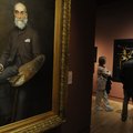 Visitors look over art Friday, Nov. 11, 2011, during the opening day at the Crystal Bridges Museum o...