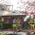 Fayetteville firefighters work to keep a fire under control that severely damaged a duplex Thursday ...