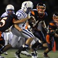 Rogers quarterback Nick Wary is wrapped up by Rogers Heritage lineback Branden Uhrig on a keeper dur...