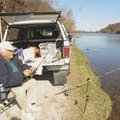 FINE FISHING DAY Guy Reedy of Rogers checks his line while fishing for trout Thursday at Lake Atalan...