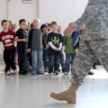 Students at J.B. Hunt Elementary School watch as Spc. Patrick Steed with the Arkansas National Guard...