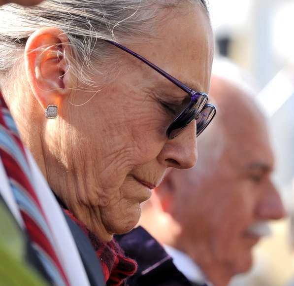 
                               
                                  Photo by David Frank Dempsey&mdash;
                               
                           
                           Alice Walton and architect Moshe Safdie bow their heads during a Veterans Day ceremony before opening festivities for the museum.
