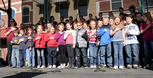 
                               
                                  Photo by David Frank Dempsey&mdash;
                               
                           
                           R.E. Baker Elementary School third-graders lead the Pledge of Allegiance at a combination Veterans Day celebration and opening ceremony for Crystal Bridges on Friday.
