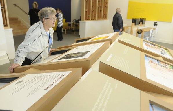 
                               
                                  Photo by Justin Wedgworth&mdash;
                               
                           
                           Gwen Janssen of Bella Vista looks over one of the interactive displays Friday during opening day at Crystal Bridges.
