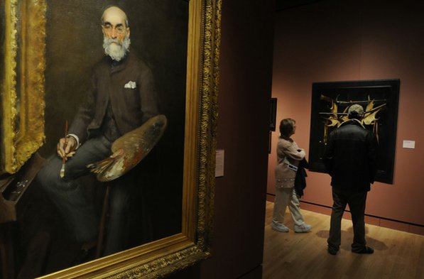 
                               
                                  Photo by Justin Wedgworth&mdash;
                               
                           
                           Two visitors look at art Friday. The painting at front, is William Merritt Chase’s “Worthington Whittredge.”
