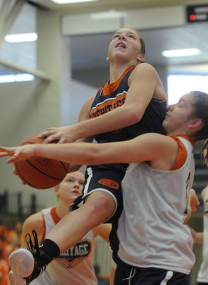 Heritage High’s Brittany Ward tries to go up for a layup on Nov. 5 during a scrimmage at Heritage High School in Rogers.