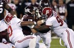 Mississippi State quarterback Tyler Russell (center) is tackled for a loss during Saturday’s game against Alabama in Starkville, Miss. Russell has completed 62 of 114 passes for 979 yards and 8 touchdowns with 4 interceptions in seven games this season. 