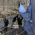 Bentonville Police investigators put up a tarp on a site where FBI and local investigators search in...