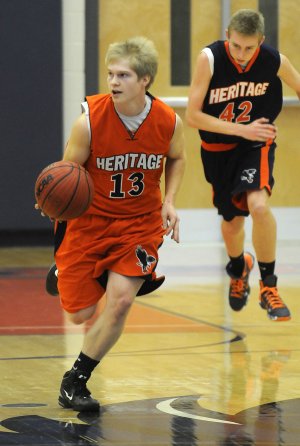 Heritage High’s Garrett Macy starts a fast break during the Blue-Orange scrimmage at War Eagle
Arena on Nov. 5.