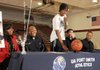 Mytaah Crawford, a Springdale High senior guard, laughs with his family and coach during a ceremony in the Bulldog gymnasium. Crawford signed a letter on intent Tuesday to play basketball for the University of Arkansas Fort Smith. Seated with Crawford is, from left, mother Vernell Crawford, brother Dre Crawford, Springdale head coach Brad Stamps and father Andre Crawford.