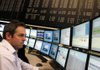 A financial trader works at his computer screens at the Frankfurt Stock Exchange in Frankfurt, Germany, on Friday, Nov. 18, 2011. European stocks declined for a second day as Germany and France differed over the role of the region's central bank in ending the debt crisis. Photographer: Ralph Orlowski/Bloomberg
