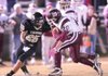 Barton running back Hunter Mauldin (20) tries to get past West Fork linebacker William Nay (25) during the first half of Friday’s game in West Fork. Barton won 23-0. 