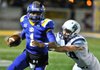 Springdale Har-Ber’s Peyton Squires tries to bring down North Little Rock quarterback Keenon Moore during Friday night’s 7A quarterfinal game in North Little Rock.
