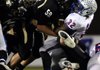 Justin Farr, a Bentonville defensive lineman, hits West Memphis running back Jarvis Cooper during the Tigers’ game Friday against the Blue Devils at Tiger Stadium in Bentonville.