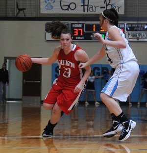 Brea Jones of Farmington drives down the court as Springdale Har-Ber’s Morgan Stephens tries to slow her down Nov. 22 at Wildcat Arena in Springdale.