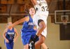 Melissa Jones, West Fork senior forward, scores as Rogers senior guard Nicole Scott defends during the first half of play Tuesday at the Tiger Dome in West Fork.