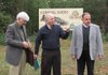 Bob Worley (from left), chairman of the Association of the Hardwood Tree board, University of Arkansas at Fort Smith history professor Billy Higgins and Chaffee Crossing Executive Director Ivy Owen talk Tuesday during an announcement that the assocation is planning a tree museum at Chaffee Crossing.