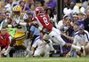 LSU wide receiver Rueben Randle, left, eludes Arkansas cornerback Tevin Mitchel (8) on a 22-yard pass play to the Arkansas 9 yard line to set up an LSU touchdown during the second quarter of their NCAA college football game in Baton Rouge, La., Friday, Nov. 25, 2011.