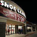 Shoppers wait outside a store Friday Morning.