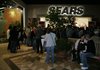 Black Friday shoppers wait outside Sears on Friday morning.