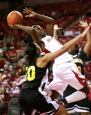 Arkansas’ Keira Peak (center) looks for a shot between Grambling State defenders Bianca McCowan (left) and Jasher Blocker during the Razorbacks’ 69-49 victory Friday night at Walton Arena in Fayetteville.