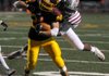 Lake Hamilton's Austin Essner (20) runs the ball as Pine Bluff's Rakeem Leverett (12) tackles him in the semi-final game at Lake Hamilton on Friday, Nov. 25, 2011. Lake Hamilton will play El Dorado for the state championship next week. (The Sentinel-Record/Mara Kuhn)